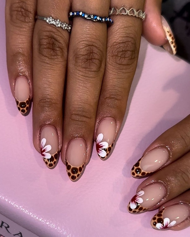 Beautiful nails featuring a unique animal print design in brown and pink with floral accents.