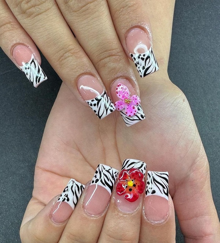 Beautiful nails featuring stylish zebra print and floral designs.